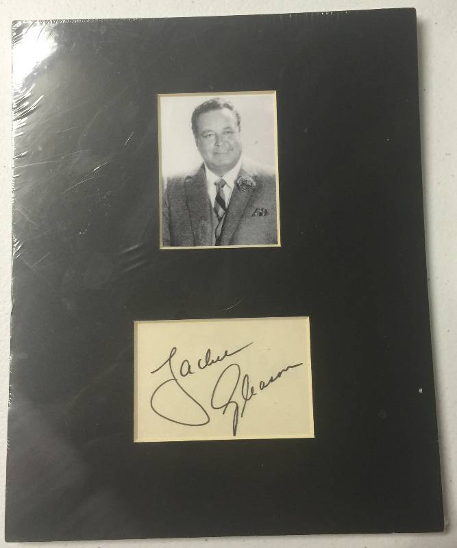 lot 1183 image: Jackie Gleason Cut Signature with Matted Picture of the Star Local Dealer Authentication