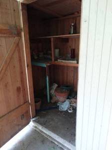 lot 38007 image: Contents of Large Cabinet-- Terracotta Pots, Birdhouse, Etc