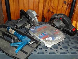 lot 38170 image: Contents of Third Shelf-- 2 Circular Saws, Caulk Gun, and Ryobi Drill Accessory Kit