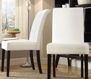 lot 19448 image: WHITE FAUX LEATHER AND BLACK LEGED 2 PC DINING CHAIR SET
