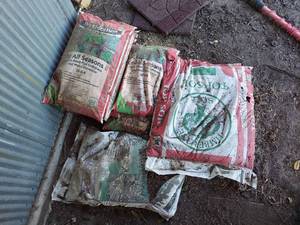 lot 1053 image: Bags of Top Soil and Fertilizer with Weed Preventer - Stored Outside, Some Bags Have Holes