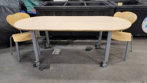 lot 1034 image: 79 in x 31 in Oval Child Size Table on Casters includes 2 Chairs