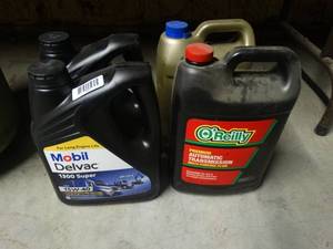 lot 1521 image: 2 gallons of oil 2 partial gallons tranny fluid