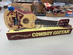 lot 48 image: Plastic cowboy schyling toy guitar