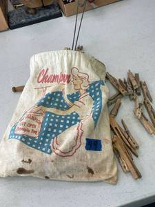 lot 49 image: The champion clothes pin bag, stay open with large quantity of clothes pins.