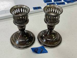 lot 87 image: weighted sterling candlestick holders.