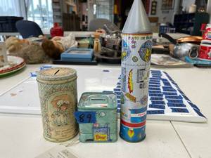 lot 89 image: tin pencil box spaceship, tin coin banks (2)
