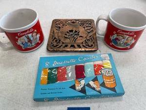 lot 117 image: campbell soup mugs, Vintage jackette coasters, trivet.