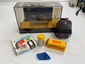 lot 128 image: Kodak disc 8000, kodak VP 127 film, kodak film case, sylvania flash bulbs, sears and roe buck marvel camera speed.