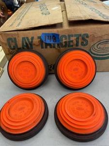 lot 148 image: Clay targets, orange and black. several different sizes.