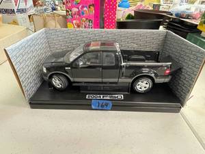 lot 164 image: 2004 F-150 black model truck.