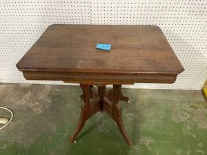 lot 182 image: Antique End table. unknown brand, with white caster wheels.