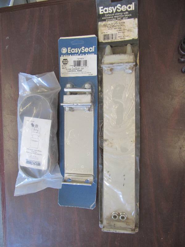 lot 602 image: 2 NEW EXHAUST EASY SEAL CLAMP AND 1 NEW BOLT STRAP STYLE CLAMP
