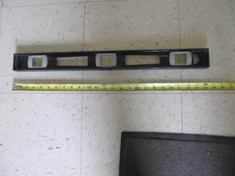 lot 2213 image: 24 JOHNSON LEVEL  MADE IN USA  Heavy duty aluminum frame,  Durable easy-read acrylic vials are impact resistant,  Top-read window maximizes readability,  Replaceable cover plates and vials