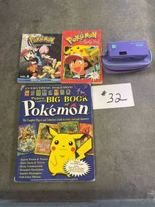 lot 32 image: Vintage pokemon books, big book of pokemon catalog, vintage vivatar purple camera with case.