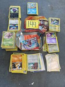 lot 144 image: Pokemon Cards and Tin