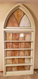 lot 104 image: 2 Vintage Stained Glass Windows Framed in Custom Made Wood Arch Shelving  HEAVY  Upstairs  42.5 x 7 x 93 in tall  one panel cracked in Arch Window see pix  2 person lift item  bring assistance
