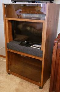 lot 145 image: Vintage OSullivan Glass Flip Top Stereo Cabinet converted to TV cabinet (TVs Not Included)  29 x 18 x 50 in. tall  on casters