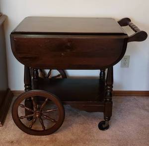 lot 334 image: Vintage Dark Wood Serving Cart with drop leaf sides & drop down handle. Closed position 32Wx20Dx28H, side leaves are 8