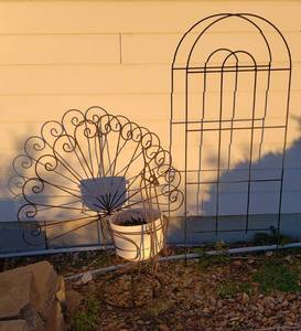 lot 1008 image: Large Metal Peacock Potted Plant Stand (32 x 22 x 28 in. tall) and Metal Tellis (18 x 46 in. tall)