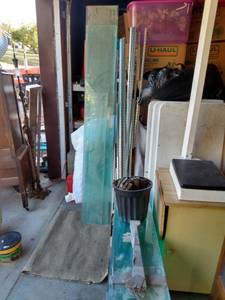 lot 872 image: glass shelving with wall brackets approximately 70 pieces of glass 40 in Long and 10 in wide one piece 49 in Long 6 in wide four pieces 70 inches long 10 in wide four pieces 76 in long and 10 in wide roller not included