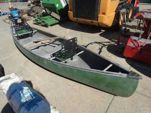 lot 1751 image: Green canoe w paddles and clip on seat backs