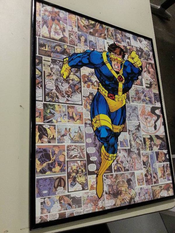 lot 8920 image: Nice framed glass poster of Superman with a collage on cartoons in the back ground.