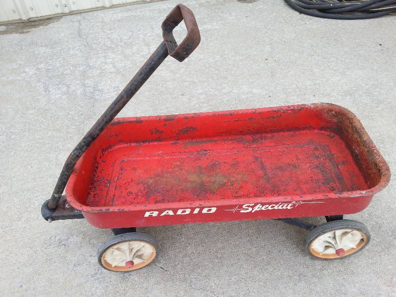 lot 9228 image: 28 X 13 RADIO Special kids wagon thats rusty and crusty but just on the top side and I noticed one wheel wobbles.