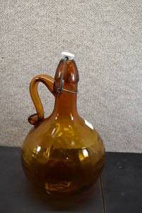 lot 5373 image: Vintage One Gallon Amber Glass Jug With Applied Handle And Ceramic Stopper  Made In Italy  13x8