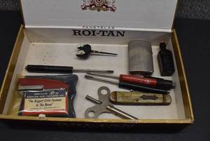 lot 1086 image: Cigar Box With Various Items  Small Glass Bottle, Flathead Screwdriver, Pocket Knife, Lighter, Mini Stapler Kit