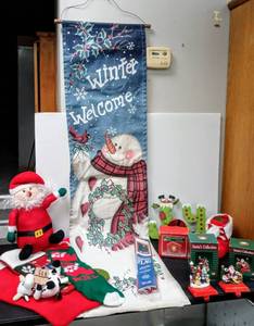lot 28099 image: Lot of Holiday Indoor & Outdoor Decor - Including Outdoor Flags & Stockings & Mantle Stocking Hangers