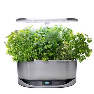 lot 103 image: AeroGarden - Bounty Elite - Easy Setup - Healthy Eating Garden kit - 9 Gourmet Herb pods included - App Capability - Stainless steel (Light didnt come on might need new light) Retails $200.00