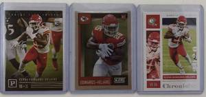 lot 1109 image: Three Mint 2020 Panini Clyde Edwards-Helaire Rookie Cards - All for One Money - Pantheon, Score Chrome, Chronicles