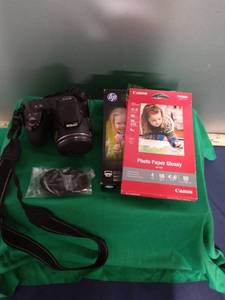 lot 100 image: Nikon Coolpix L810 Camera, Wrist Strap, and Photo Paper (camera screen has crack in it, takes 4 AA batteries)