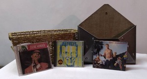 lot 145 image: Woven Basket, Metal Letter Basket and 3 CDs (Nick Swardson is missing a disc)