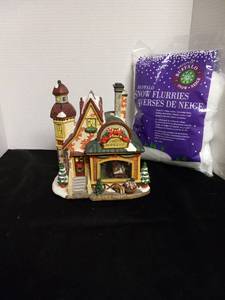 lot 6 image: Norman Rockwell Collection Santa Reading Mail Hand-painted Porcelain House with a bag of Snow Flurries. Please note back side is broke but appears it could be fixed