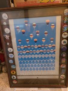 lot 1046 image: Wichita River Festival Buttons 1972 to 1995 with a 1984 poster in a shadow box, 36x28x2