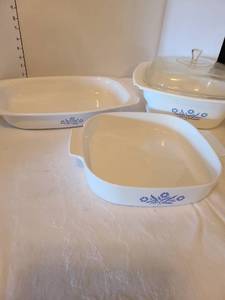 lot 1115 image: Cornflower blue Corningware. The 4 qt. Dutch oven has chips on lid and dish.