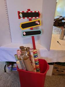 lot 1213 image: Red trash can with wrapping paper and sign