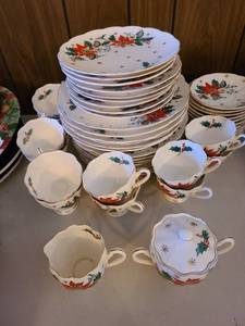 lot 1217 image: Poinsettia pattern dishes, 48 pieces. Sugar bowl has crack in lid. Bring own box and packing.
