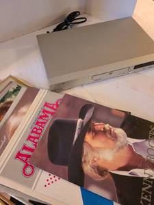 lot 1304 image: Pioneer DVD player, no remote, variety of country singers promos