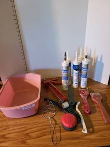 lot 2025 image: Caulking gun with caulk and and wallpaper tools