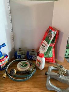 lot 2053 image: Lawn and garden supplies including weed and feed, sprinkler, timers, hose and nozzle