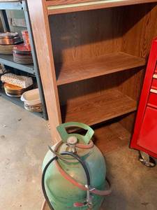 lot 2095 image: Propane tank and bookshelf 24 x 12 x 39 high