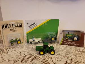 lot 175 image: NIB John Deere 5020 Tractor 164 Scale Diecast Metal, NIB John Deere 4WD Pickup with Tractor and Trailer 164 Scale Diecast Metal, NIB John Deere 1958 Model 630LP Tractor 143 Scale Diecast Metal, and John Deere Tractor