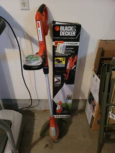 lot 438 image: Black & Decker Lithium Battery Operated Weed Eater with 2 Batteries and Charger (works)