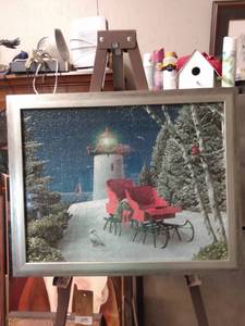 lot 4233 image: framed puzzle of Christmas sleigh and lighthouse 20 in wide 16 in tall