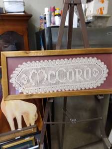 lot 4242 image: framed crocheted peace with the name McCord 26 inches wide 10 in tall