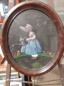 lot 4287 image: oval framed needlepoint of little girl watering garden 12 and 12 in wide 14 and 12 in tall