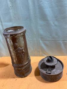 lot 7330 image: One old oil lamp bottom and a vintage face with the Statue of Liberty on it